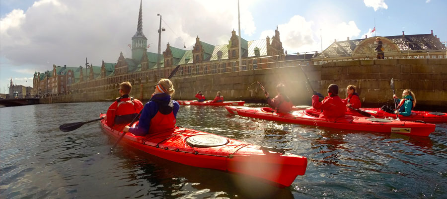 Group of kayakers sailing in front of Christiansborg, Copenhagen