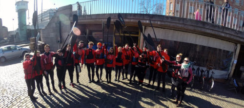 Team of kayak rowers in front of Kayak Republic